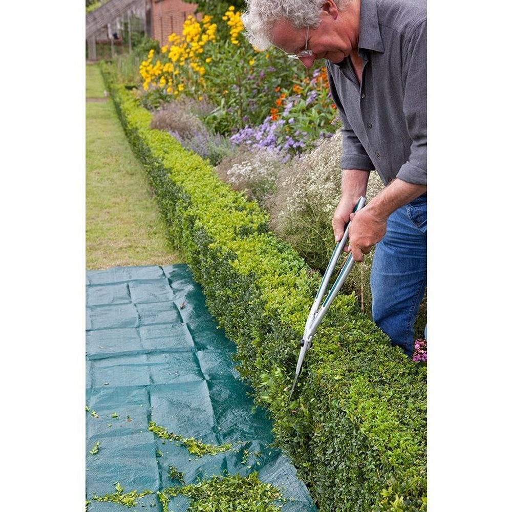 Gardener using the Topiary Hedge Shears by Burgon &amp; Ball