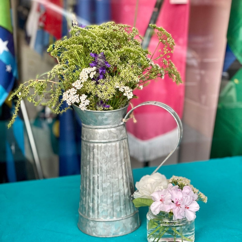 galvanised watering jug with cottage flowers